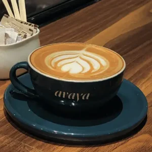 Creamy cafe latte with frothy foam and rich espresso served in a cup at Avaya Café