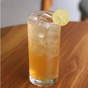 Glass of refreshing lemon iced tea with ice cubes and fresh lemon slices at a café