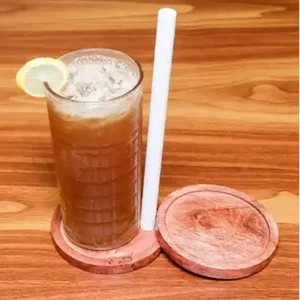 Glass of refreshing peach iced tea with ice cubes and fresh peach slices served chilled in a café style setting