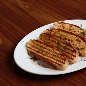Freshly baked crispy garlic bread with buttery garlic topping, served hot.