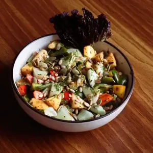 Iron Feast Veg and Chicken served hot with fresh herbs and vibrant veggies at café style.