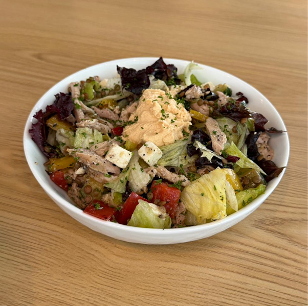 Protein bomb salad with lettuce grilled chicken paneer vegetables hummus and dressing served fresh at Avayacafe