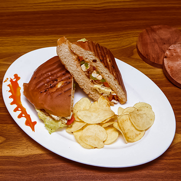 Healthy garden fresh veg or chicken sub sandwich with grilled vegetables cheese and lettuce served at Avayacafe with potato chips