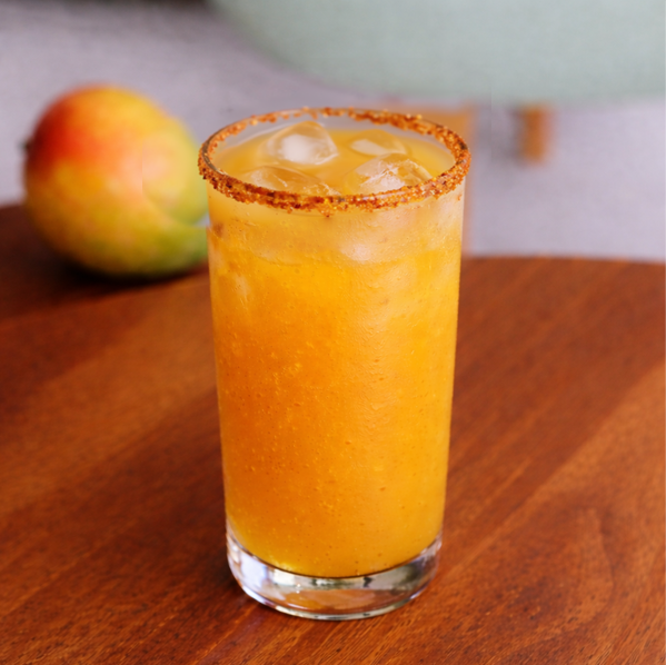 Glass of Alphonso Twist mango drink with mint and mango cubes at Avayacafe.