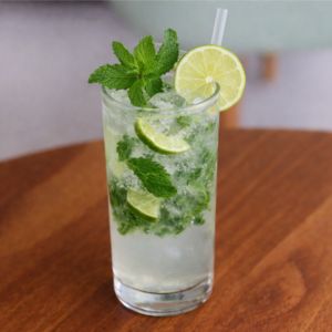 Classic mojito drink with fresh mint leaves, lime wedges, ice, and soda served at Avayacafe.