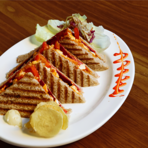 Lal Pahadi veg or chicken sandwich with sourdough bread paneer vegetables cheese served at Avayacafe with chips and sriracha mayo