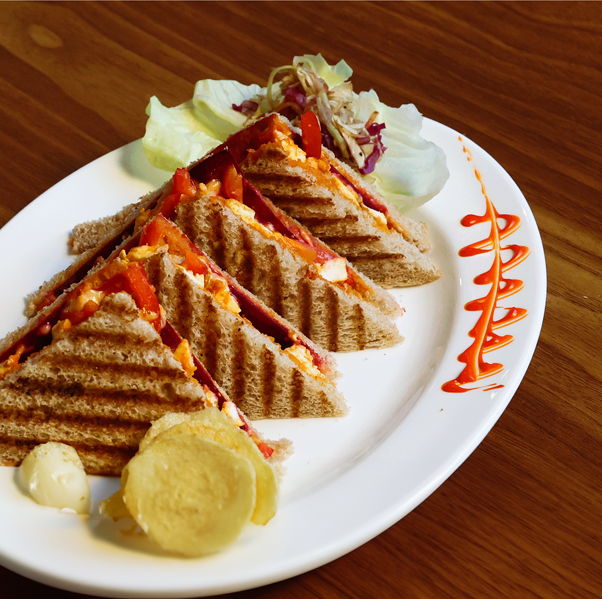 Lal Pahadi veg or chicken sandwich with sourdough bread paneer vegetables cheese served at Avayacafe with chips and sriracha mayo